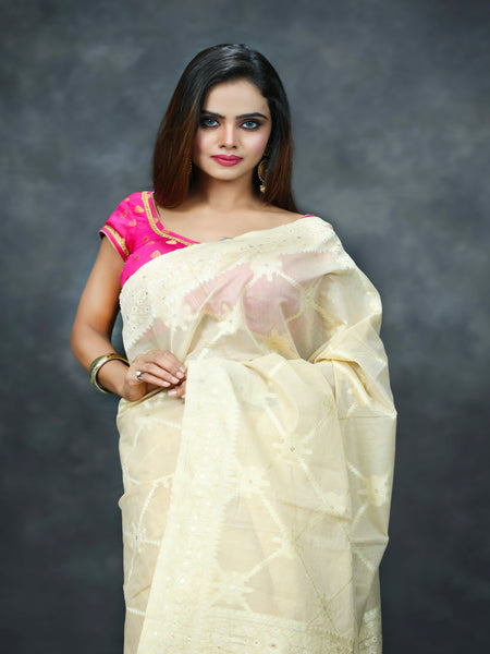 Raj Nandini In Cream Banarsi Silk Saree With Meena Border And Booti Work. Available in 3 colours.