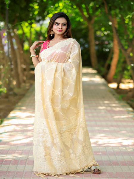 Raj Nandini In Cream Banarsi Silk Saree With Meena Border And Booti Work. Available in 3 colours.